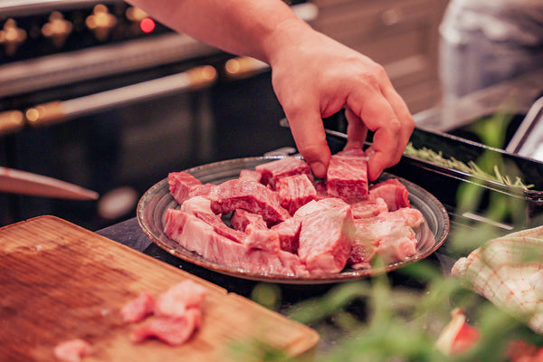 Picture of Japanese Wagyu being cut on a wooden tray